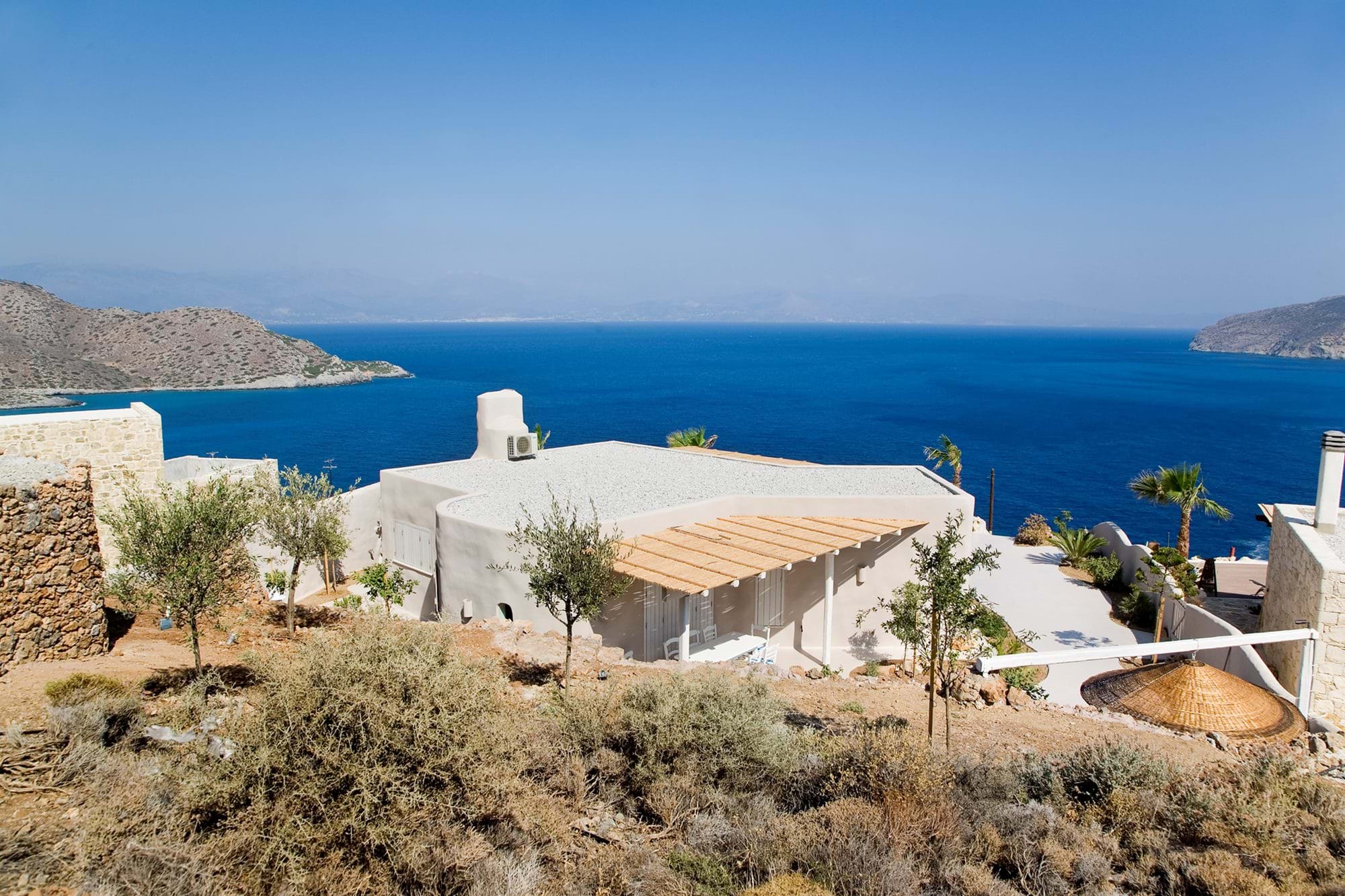 Villa among olive trees above the sea